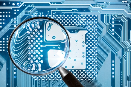 Example of a computer component board with a magnifying glass above