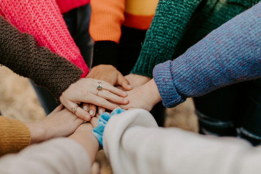 Group of volunteers stacking hands together