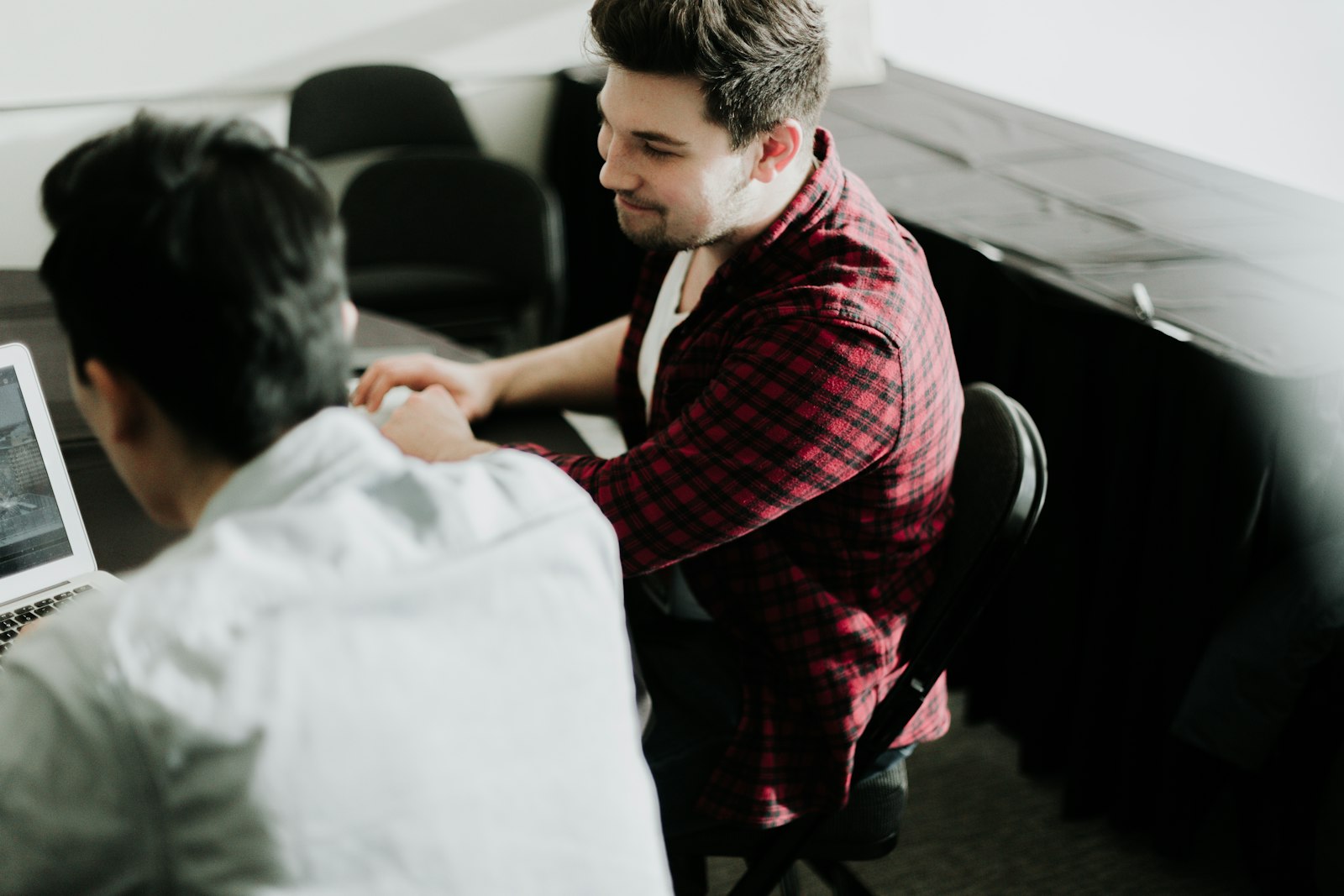 Business and IT support professionals shaking hands