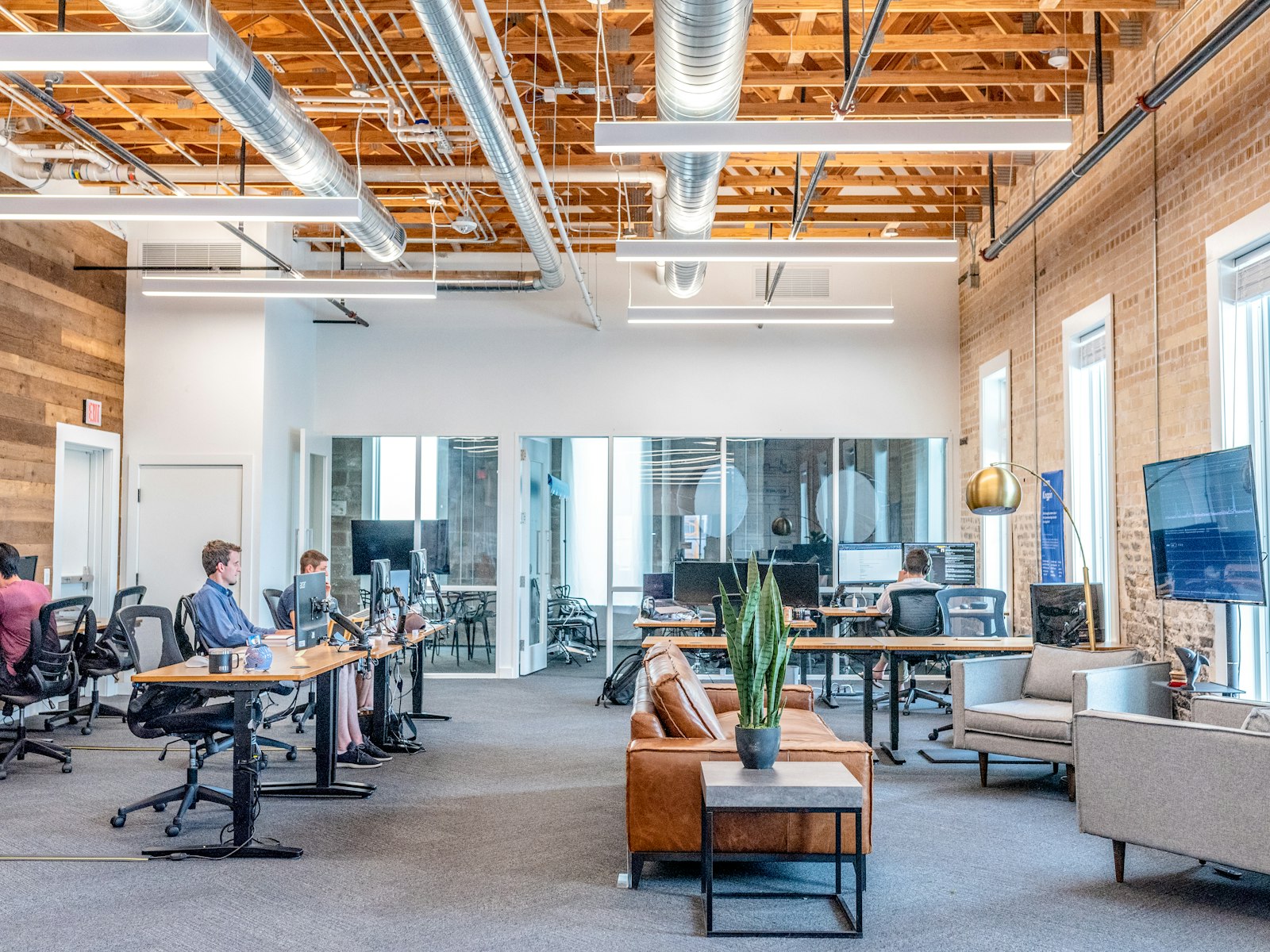 Open-plan office with staff working at multiple computer workstations
